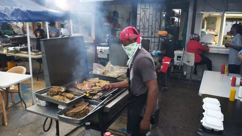 A local cook grills at Oistins Fish Fry in Barbados